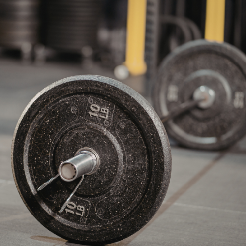 Person increasing weights on a barbell